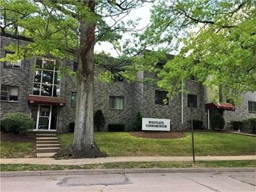 Pittsburgh apartment for rent - a building with a sign in front of a tree