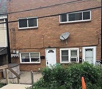 Pittsburgh apartment for rent - a brick building with a satellite on the side of it