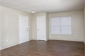 Peoria apartment for rent - an empty living room with two doors and a window