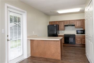 Peoria apartment for rent - a kitchen with an island and a black refrigerator