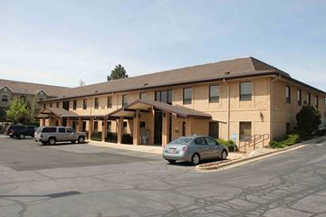 Kaysville apartment for rent - A parking lot in front of a building with cars parked.