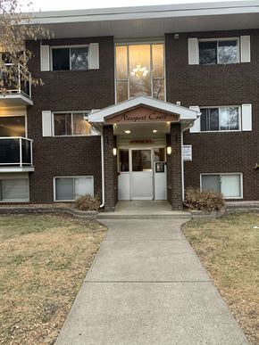 Edmonton house for rent - the front entrance of a brick building with a white door