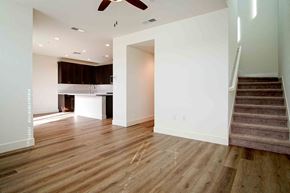 Hollister apartment for rent - an empty living room with a staircase and a kitchen