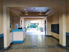 Honolulu apartment for rent - A hallway with a blue and white reception desk.