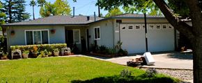 San Jose house for rent - A house with a white garage door and a tree in front.