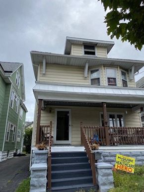 Buffalo apartment for rent - A house with a sign that says "MCGUIRE HEALTHCARE HERO".
