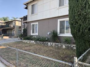 Winnetka apartment for rent - a house with a yard behind a chain link fence