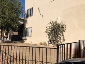 Canoga Park apartment for rent - A black fence in front of a beige building with the number 726 on it.