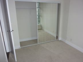 Vancouver apartment for rent - A room with a white door and a glass door.