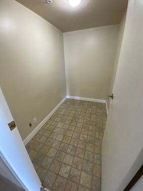 Vancouver apartment for rent - A room with a tiled floor and a light on the ceiling.