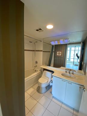 Vancouver apartment for rent - A white bathroom with a toilet, sink, and bathtub.