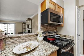Malden apartment for rent - a kitchen with a stove top oven and a sink