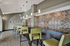 Malden apartment for rent - a dining area with a long table and chairs and a brick wall