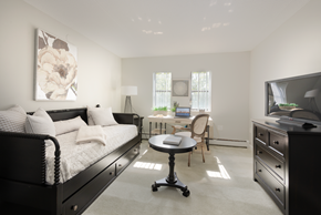 Malden apartment for rent - a bedroom with a bed and a desk with a chair and a television