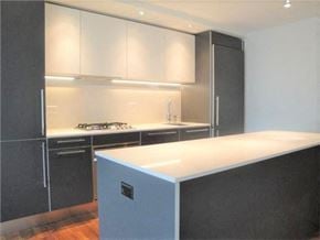 Vancouver apartment for rent - A kitchen with a white counter top and black cabinets.