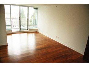 Vancouver apartment for rent - A room with a window and wooden floors.