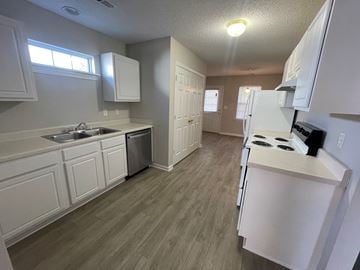 Rocky Mount apartment for rent - A kitchen with white cabinets and a stove top oven.