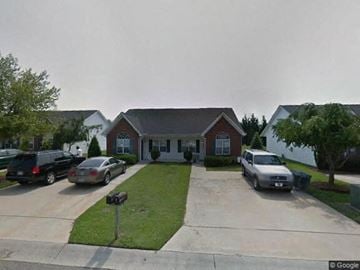Rocky Mount apartment for rent - A house with a driveway and cars parked in front.