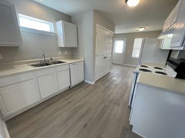 Rocky Mount apartment for rent - A kitchen with white cabinets and a wooden floor.