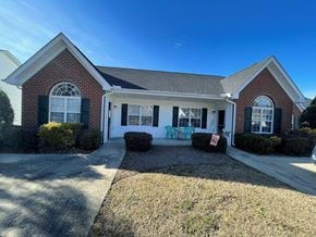 Rocky Mount apartment for rent - A house with a red brick exterior and a white front porch.