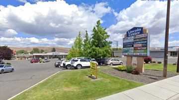 Yakima apartment for rent - A parking lot with cars and a sign for Lincoln Center.