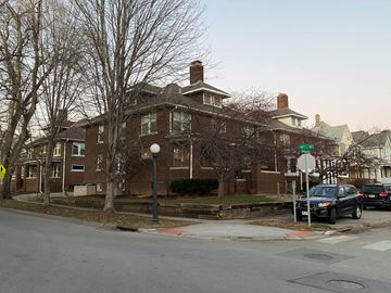 Omaha apartment for rent - a large brick house with cars parked in front of it