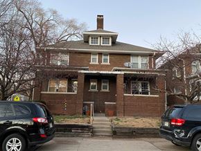 Omaha apartment for rent - a brick house with cars parked in front of it