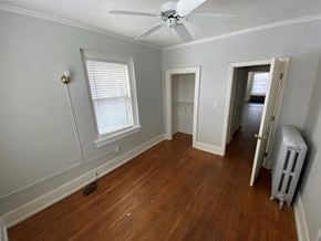 Omaha apartment for rent - a living room with wood floors and a ceiling fan