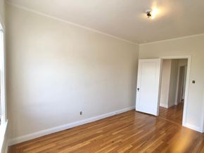 Alameda apartment for rent - A room with wooden floors and white walls.