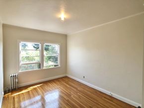 Alameda apartment for rent - A room with wooden floors and a window.