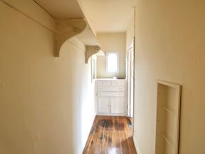 Alameda apartment for rent - A long hallway with a wooden floor and white walls.