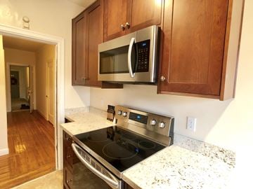 Alameda apartment for rent - A kitchen with a stove and microwave above it.