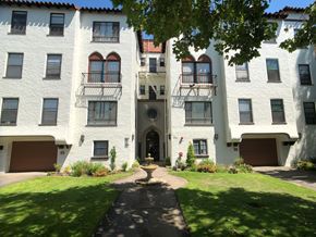 Alameda apartment for rent - A white building with a brown door and windows.