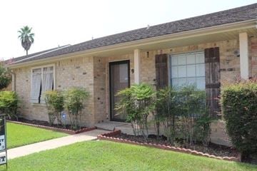 Beaumont house for rent - a brick house with a front porch and a lawn