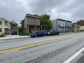 Omaha apartment for rent - A blue car is parked on the side of a street.