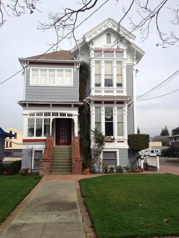 Alameda apartment for rent - A two-story house with a red door and white trim.