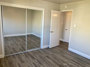 Oakland apartment for rent - A room with a sliding door and a white door.