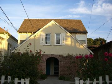 Alameda apartment for rent - A house with a white fence and a green door.