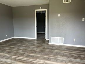Killeen apartment for rent - a living room with wood floors and grey walls and a door