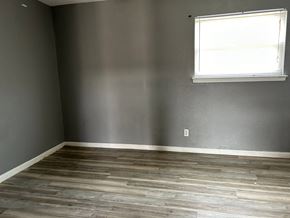 Killeen apartment for rent - a room with grey walls and a window and wooden floors