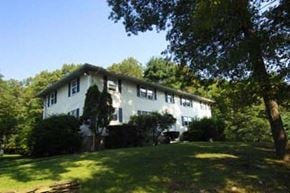 Foxboro apartment for rent - a white house on a hill with trees