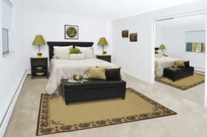 Nashua apartment for rent - a bedroom with a large bed and a mirror