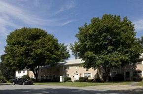 Nashua apartment for rent - a house with a car parked in front of some trees