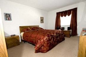 Keene apartment for rent - a bedroom with a bed with a red comforter