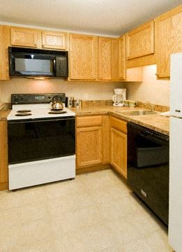 Mansfield apartment for rent - a kitchen with black and white appliances and wooden cabinets