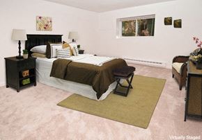 Mansfield apartment for rent - a bedroom with a bed and a couch and a window