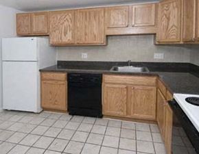 Foxboro apartment for rent - a kitchen with wooden cabinets and a white refrigerator