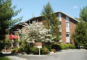 Foxboro apartment for rent - a building with a flowering tree in front of it