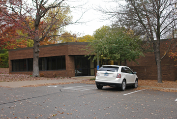 Wayzata apartment for rent - a car parked in a parking lot in front of a building