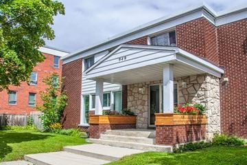 Ottawa apartment for rent - the front of a brick building with steps and a porch